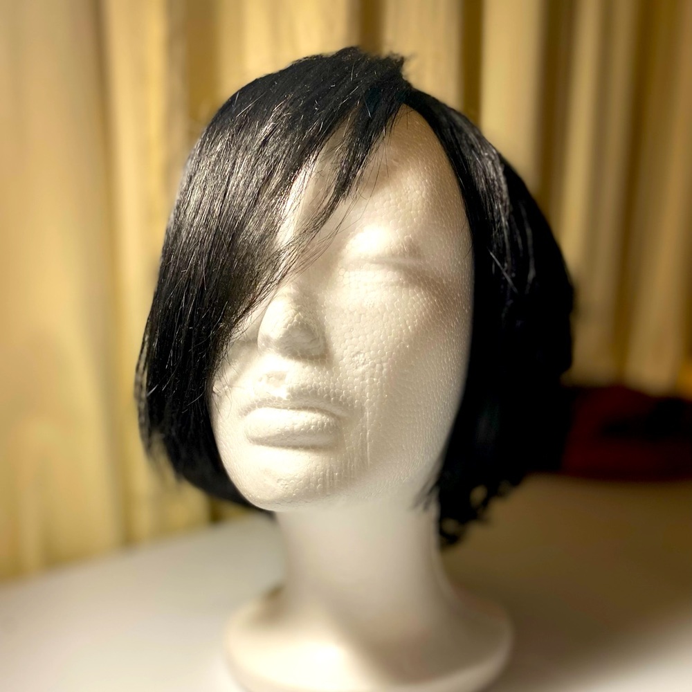 Short, black, bob wig with few curls.